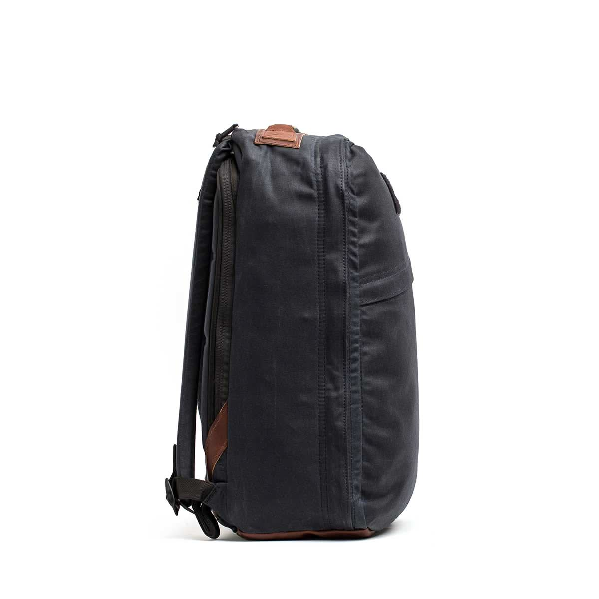 A side view of the GR1 USA - Heritage by GORUCK, featuring its black design with brown accents, focusing on the sturdy straps and zippers.