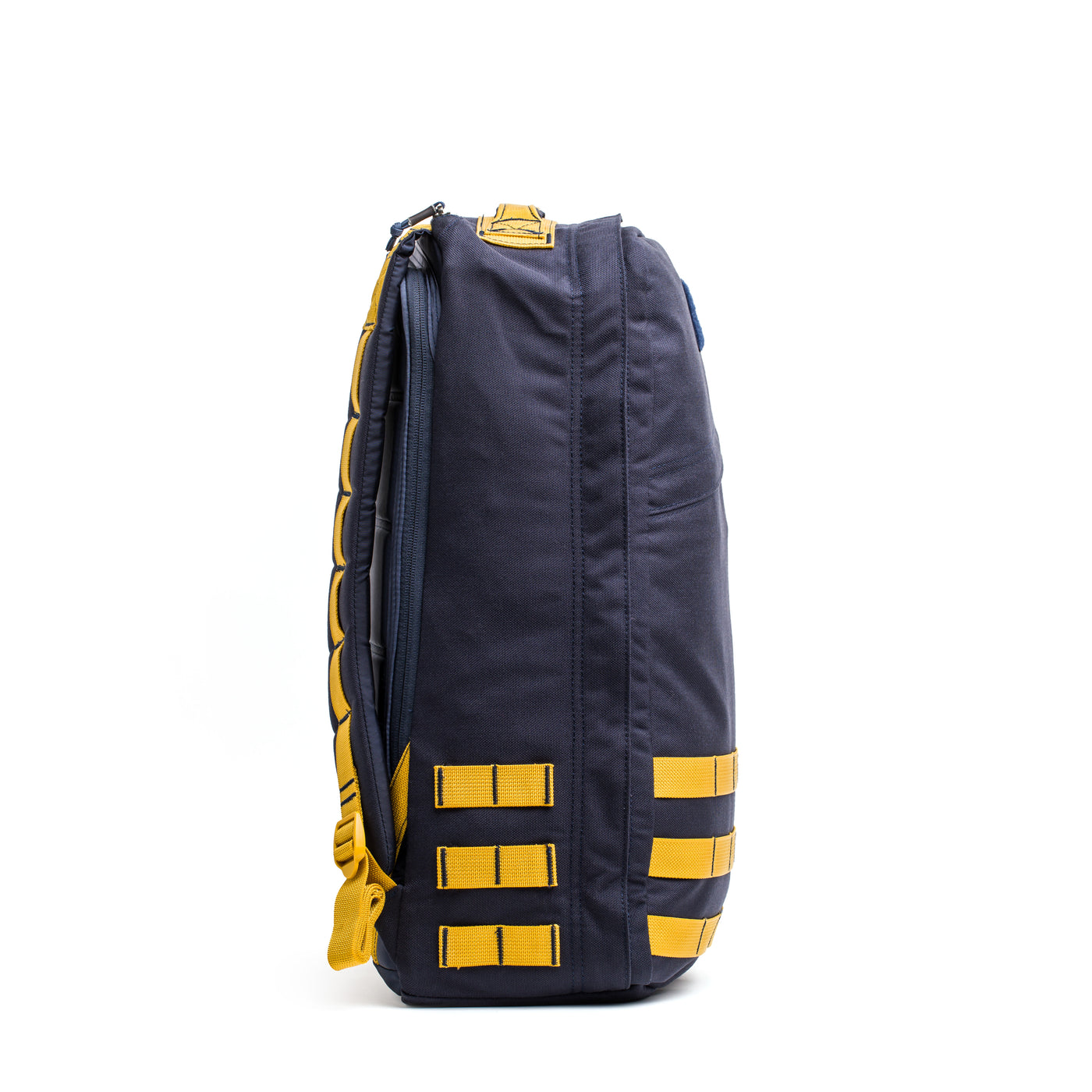 Side view of a navy blue GR1 USA - Cordura (The Original Ruck) from GORUCK, featuring yellow straps and details along with a bombproof laptop compartment, isolated on a white background.