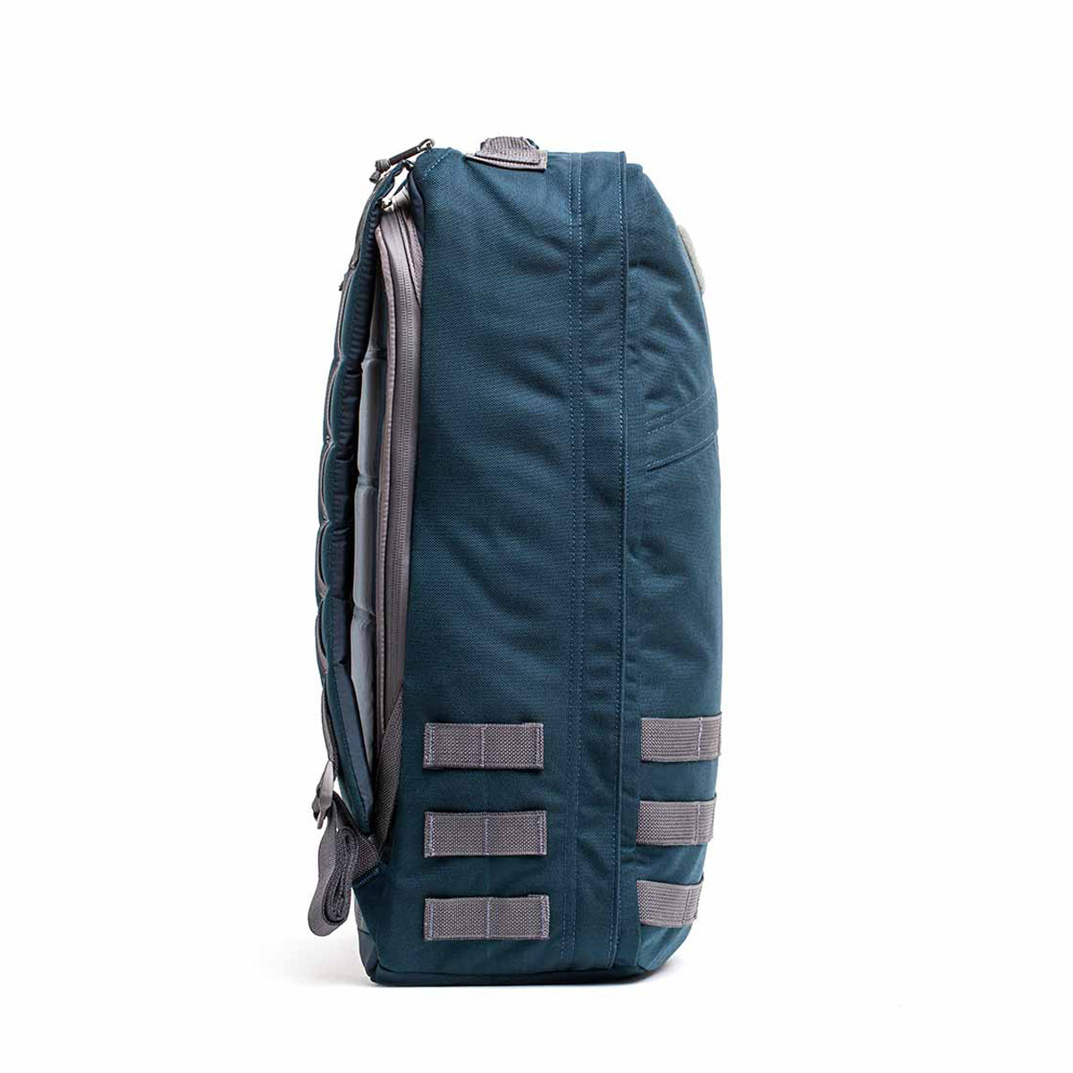 Side view of the GR1 USA - Cordura (The Original Ruck) in blue and gray, made with Special Forces grade materials. It includes multiple horizontal loops, a top handle, and is built for GORUCK Challenge-level durability.