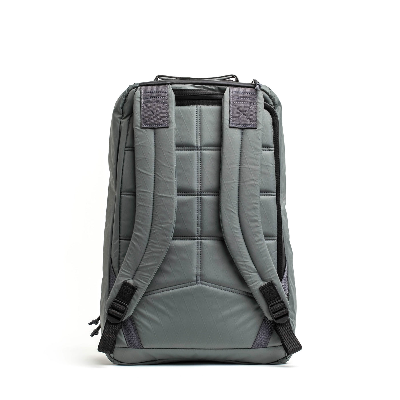 The GR1 USA - X-PAC rucksack by GORUCK is displayed from the back, highlighting its padded, adjustable shoulder straps and quilted design. Crafted with X-PAC material to ensure waterproof capability, it features black accents at the ends of the straps and a small handle on top.