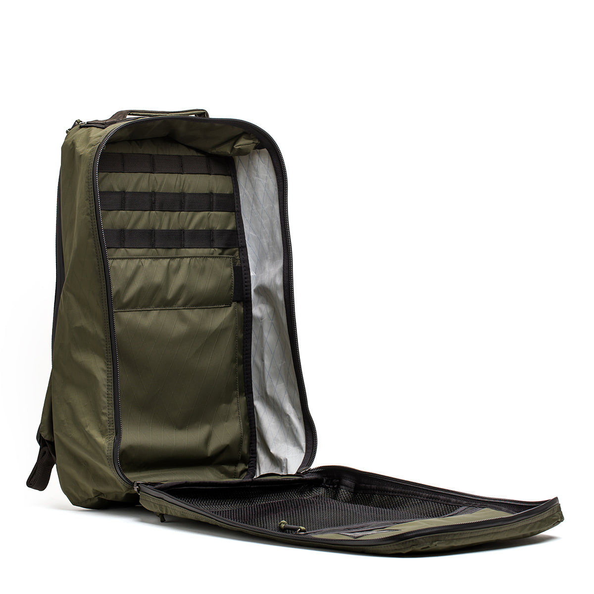 The GR1 USA - X-PAC is an olive green rucksack, crafted from waterproof X-PAC material, featuring multiple compartments and mesh pockets, standing upright.