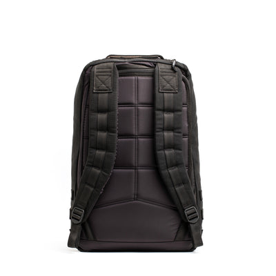 The GR1 Birdwell backpack by GORUCK is featured from the back, highlighting its padded shoulder straps and quilted design that exemplify the brand's signature style. Made from durable SurfNyl™️ fabric and equipped with adjustable buckles for a secure fit, it stands out against a clean white background.