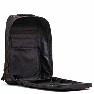 The GR1 USA Throwback is an open black backpack with a bombproof laptop compartment, organized interior zippers, and made from durable 1680 ballistic nylon. It stands upright on a white background.