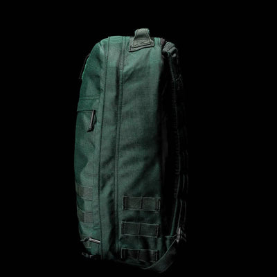 Side view of the dark green GR1 USA - Cordura backpack by GORUCK set against a black background, highlighting its robust rucksack design tailored for Special Forces.