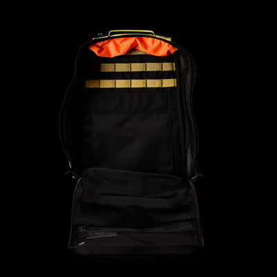 Display the GR1 USA - Cordura (The Original Ruck) by GORUCK, a black backpack featuring an orange interior and tan straps, designed against a sleek black background.