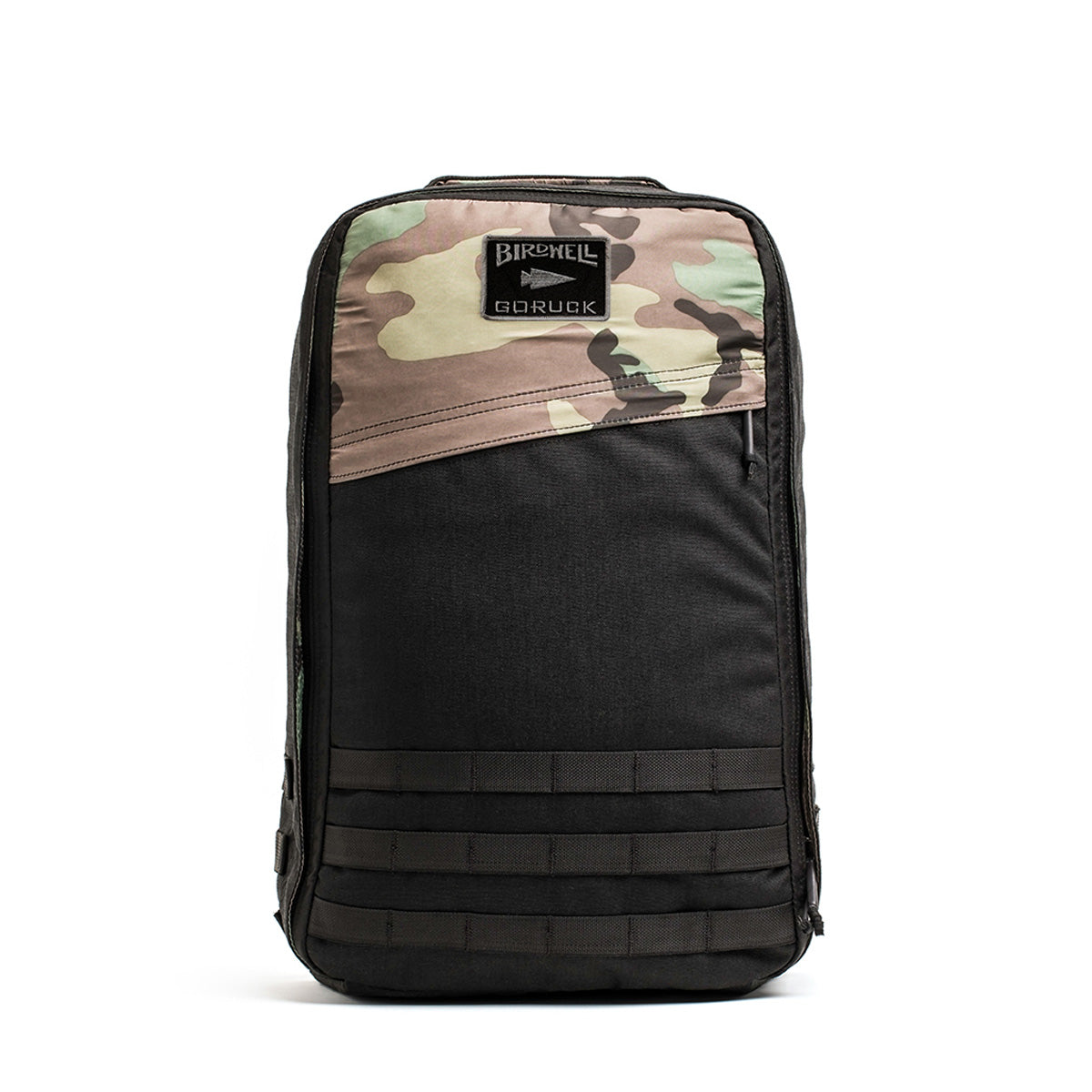 The GR1 Birdwell by GORUCK is a backpack adorned with a camouflage and black design. It features a patch on the front labeled Birdwell x GORUCK GR1, with the upper part displaying a SurfNyl™️ camo pattern and the lower section in solid black complemented by horizontal webbing strips, exemplifying American craftsmanship.