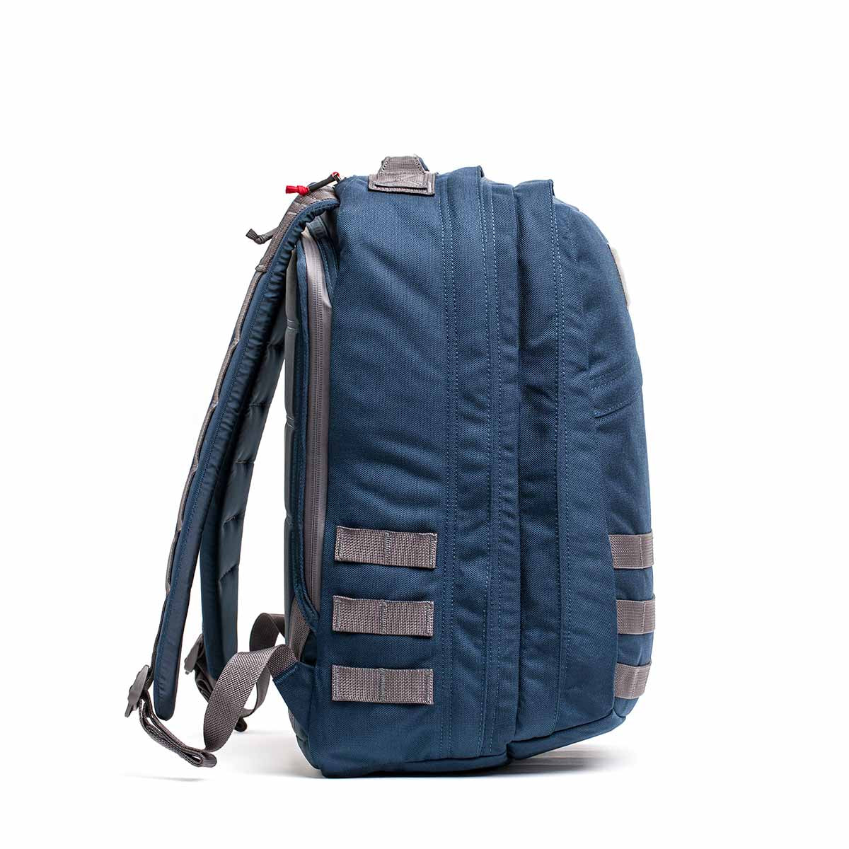 Side view of a blue GR2 backpack made from Cordura, featuring gray straps and a top handle, designed to match the robust functionality favored by Special Forces.