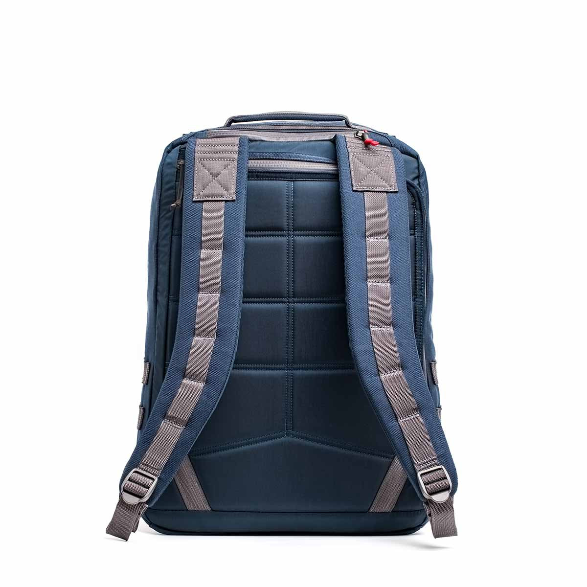 The GR2 - Cordura backpack in navy blue, shown from the back with gray straps, features padded support and a top handle, ideal for those seeking ruck-ready functionality.