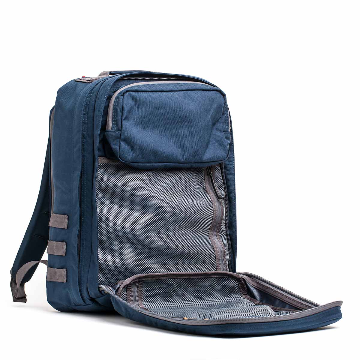 A blue GR2 - Cordura backpack with its front compartment open reveals a mesh interior, reminiscent of its organizational and functional design.