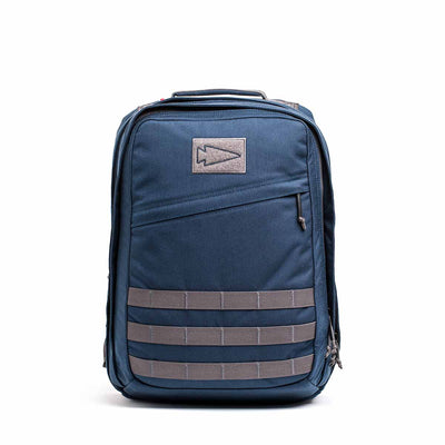 The GR2 - Cordura is a blue backpack with gray straps and a triangular logo on the front pocket, designed to meet Special Forces standards.