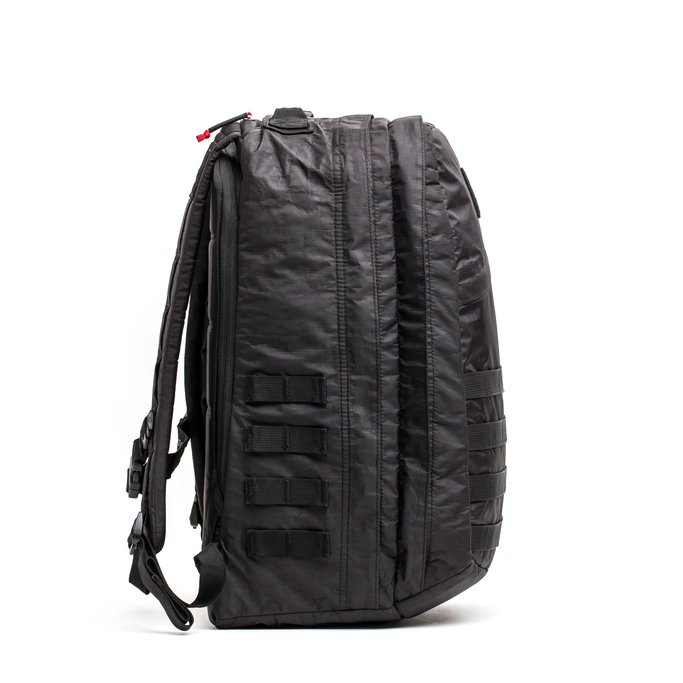 The GORUCK GR2 - Dyneema backpack, available in a sleek black color, includes multiple zippers and side MOLLE webbing. Crafted with abrasion-resistant materials for enhanced versatility and durability, it features adjustable shoulder straps and a sturdy top handle to complete its Dyneema®-enhanced design.