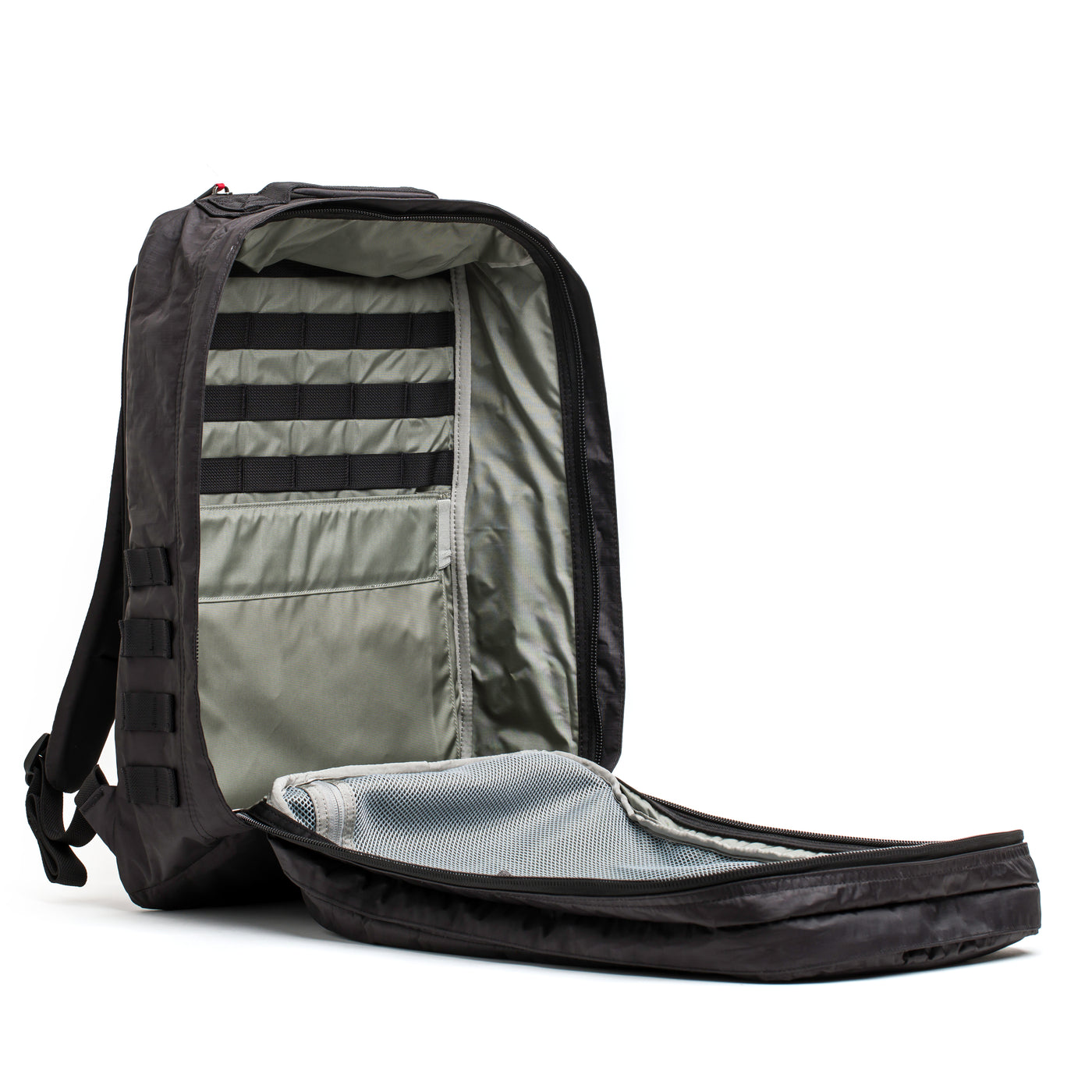 The GR2 - Dyneema by GORUCK is displayed with its spacious interior open, showcasing a neatly organized interior made from abrasion-resistant Dyneema®. It includes multiple compartments and pockets designed for holding a laptop and accessories, along with padded shoulder straps to ensure comfort.