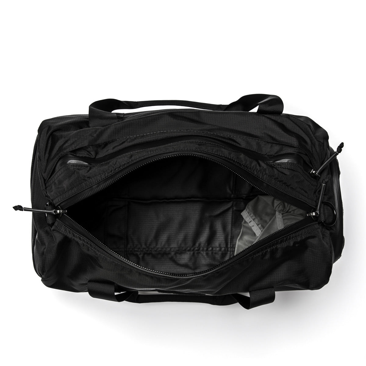 A black Gym Bag - Ripstop ROBIC® by GORUCK is shown with its main compartment open, displaying an empty interior. Crafted from robust ripstop nylon, it comes with two handles and a shoulder strap. The minimalist design and zippers accentuate its sleek appearance on a white background, making it perfect for your workout essentials.