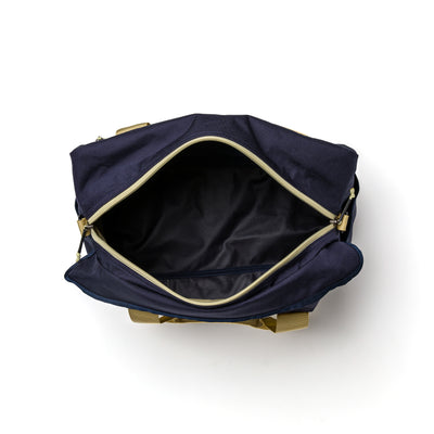 Reveal the empty interior and zipper of the open navy blue GORUCK Kit Bag (Includes Shoulder Strap) with its beige handles.