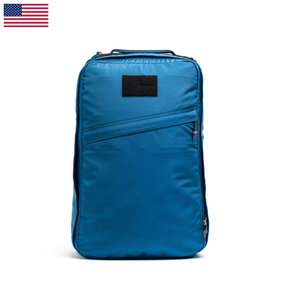 The GR1 USA - Ripstop ROBIC® is a blue travel backpack featuring a small black patch and USA flag icon, crafted from ultra-lightweight Ripstop Nylon.