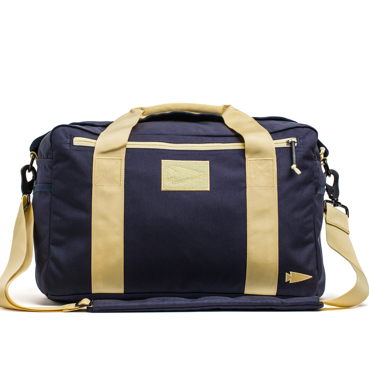 The navy blue Kit Bag by GORUCK, featuring beige handles and detailing reminiscent of an Aviator's Kit Bag, includes a shoulder strap and displays a small arrow logo.