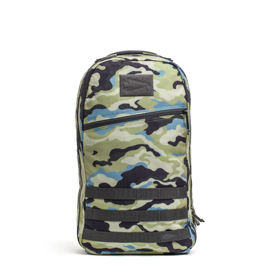 The Bullet Ruck Classic - Cordura by GORUCK features a camouflage-patterned design, multiple zippers, a rectangular black patch on the front, and padded straps for added comfort.