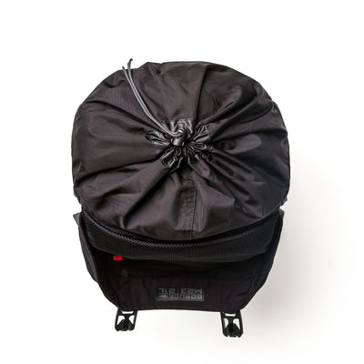 Top view of the GORUCK M23 - Cordura, a sleek black rucksack made from durable materials, featuring a drawstring closure and two clip buckles.