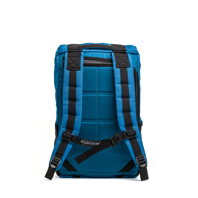 The GORUCK M24 - Ripstop ROBIC® is a stylish blue and black modern rucksack with padded straps and buckle closures, designed from durable materials, shown from the back.