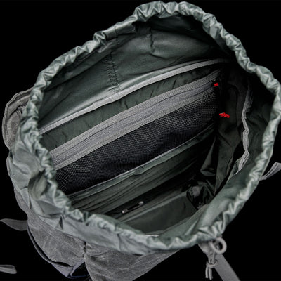 A top view of GORUCK's modern M24 Waxed Canvas showcases its interior compartments, featuring a zippered pocket and mesh organizer. This stylish rucksack includes a drawstring closure and is crafted from durable dark gray fabric.