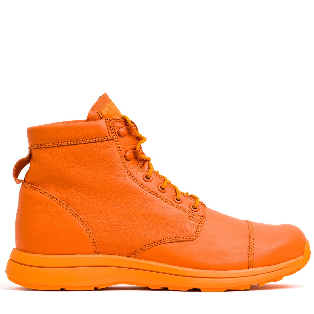 The MACV-1 Traveler x Carryology - Berserker Viking by GORUCK is an orange leather lace-up ankle boot featuring a smooth finish and a pull tab at the back. Designed with a padded collar and matching orange sole, it is crafted from water-resistant leather, making it perfect for travel, adventure, casual outings, or outdoor wear.