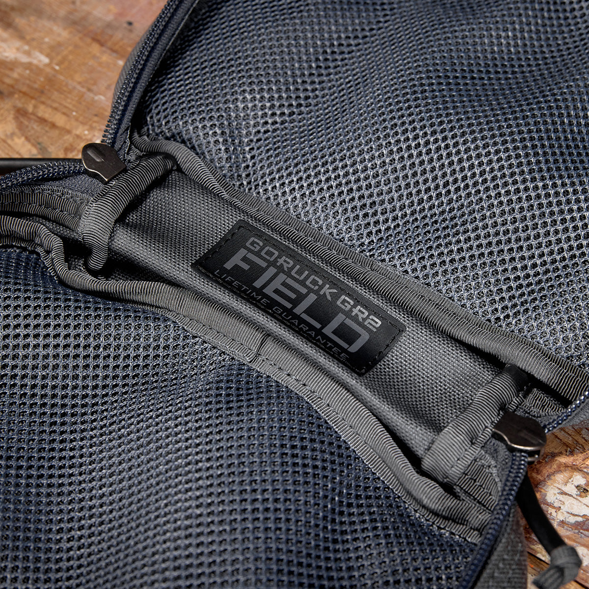 Close-up of a GORUCK GR2 Field Pocket, open to reveal the label on a gray mesh interior. Crafted from durable 1000D Cordura, it seamlessly complements any electronics organizer with its practical design.