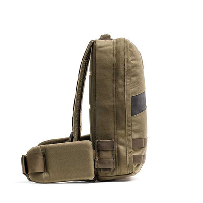 Side view of a khaki Rucker 4.0 backpack featuring padded straps and black horizontal detail, ideal for rucking enthusiasts as a training tool.