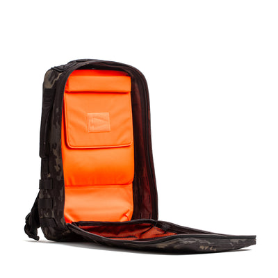 Introducing the Rucker 4.0 backpack with an open black design, bright orange interior, and multiple compartments—ideal for carrying your gear or adding Ruck Plates for the ultimate rucking experience.