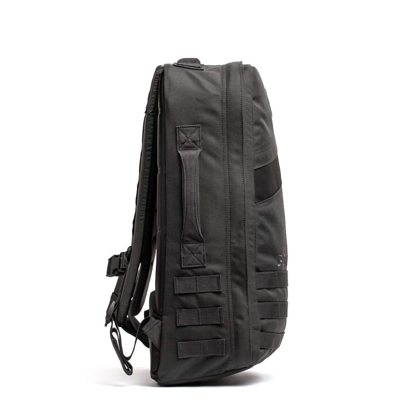 A sleek black GORUCK Rucker 4.0 backpack with a modern design, featuring multiple horizontal straps and a side handle. This rucksack has a slim profile, showcasing its compact and versatile structure against a plain white background.