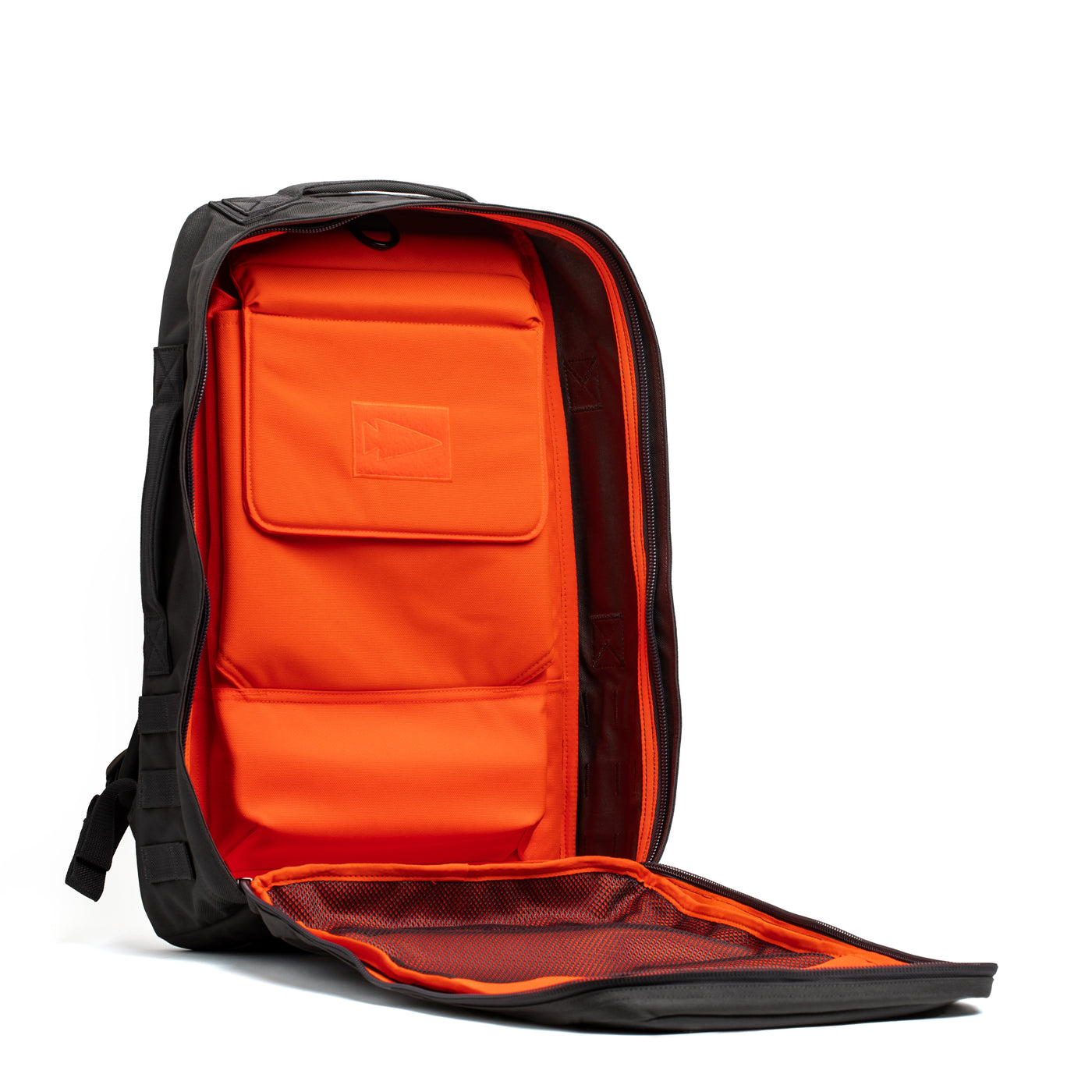 The GORUCK Rucker 4.0 is a sleek and modern black rucksack featuring an open front that reveals a vibrant orange interior. Inside, it offers multiple compartments for organizing items, including a padded section and mesh pocket.