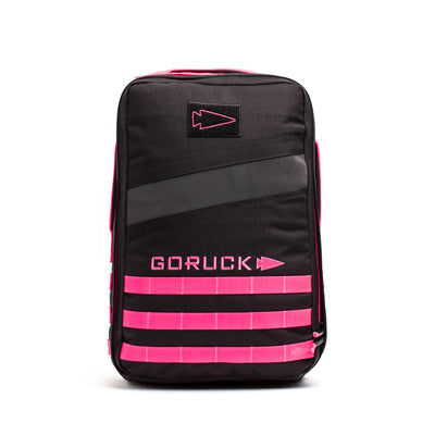 The Rucker 4.0 is a black rucksack with pink accents, adorned with a "GORUCK" logo and horizontal front straps, ideal for rucking adventures.