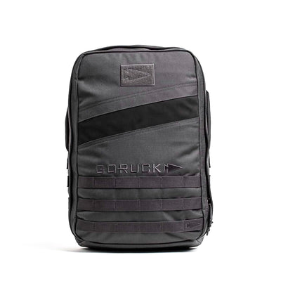 The Rucker 4.0 gray rucksack boasts black diagonal stripes and multiple compartments, ideal for rucking adventures, all displayed on a crisp white background.