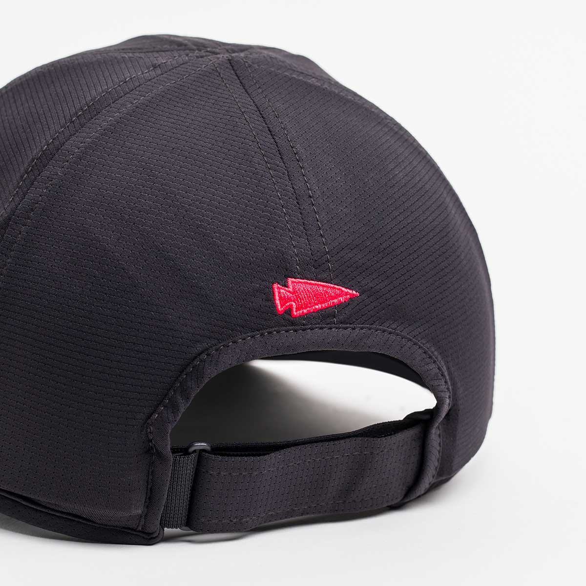 The Performance Running Hat - ToughMesh shows a back view of its featherweight black design, featuring a red arrowhead near the adjustable strap and made from premium Italian fabric.