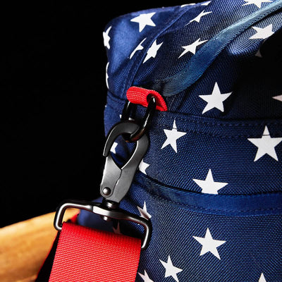 Close-up of a Kit Bag (Includes Shoulder Strap) in blue, featuring white stars and a red strap attached with a black clasp.