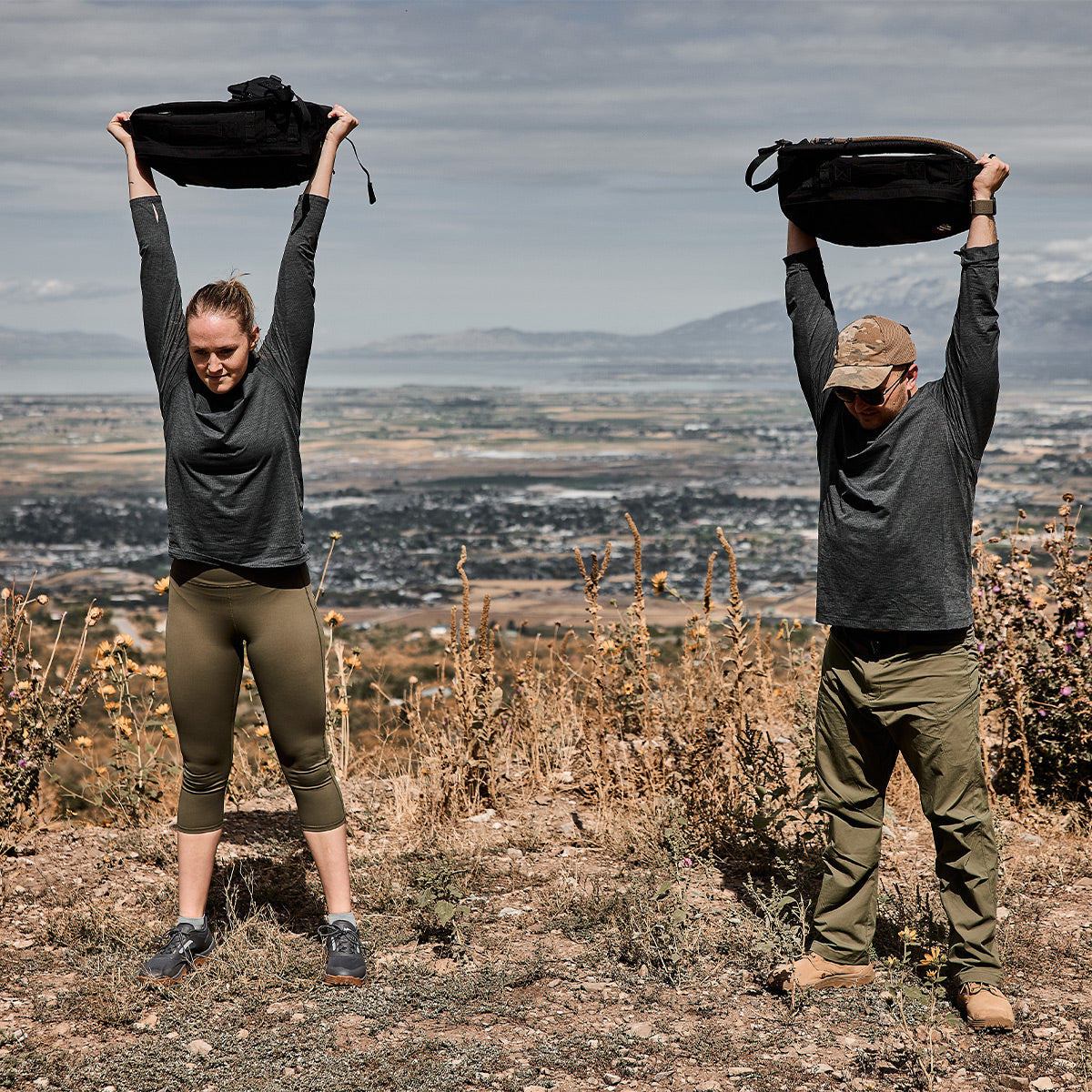 Two people working out in the mountains wearing Men's Long Sleeve Performance Tee - ToughMesh Charcoal