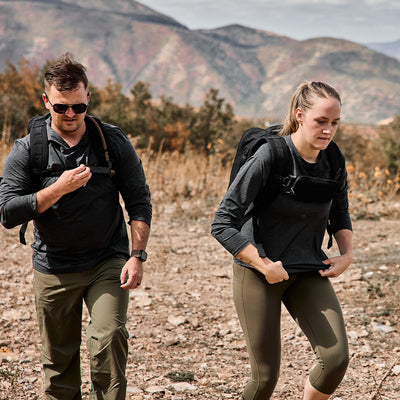 Two people rucking in the mountains. Man is wearing Men's Long Sleeve Performance Tee - ToughMesh Charcoal