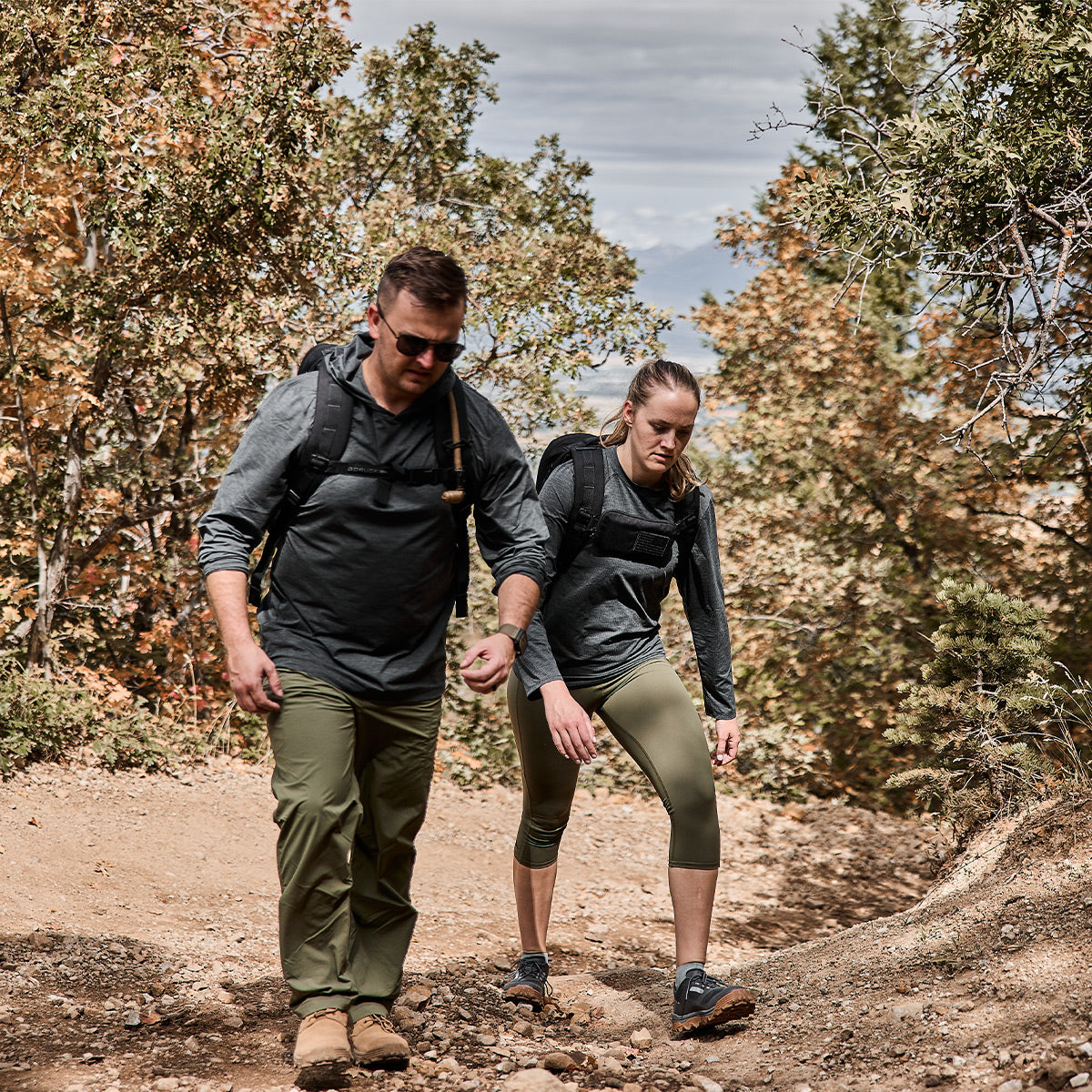 Two people rucking in the mountains. Man is wearing Men's Long Sleeve Performance Tee - ToughMesh Charcoal