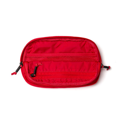 The GORUCK Belt Bag is a small, red zippered pouch that serves as an ideal Compact Belt Bag. It features multiple compartments with both mesh and solid sections, equipped with two zipper pulls and adjustable webbing. Its sleek yet practical design lies flat against a plain white background, making gear organization effortless.