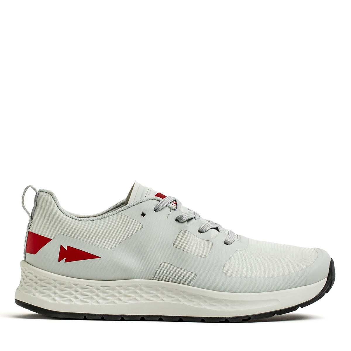 Introducing the Women's Rough Runner by GORUCK: a high-mileage running shoe in a light grey and red color scheme, featuring an athletic white design with a textured sole. It includes gray laces and is adorned with an eye-catching red arrow-shaped design near the heel. The shoe is equipped with a Gradient Density EVA Midsole for superior comfort, making it perfect for any runner's journey.