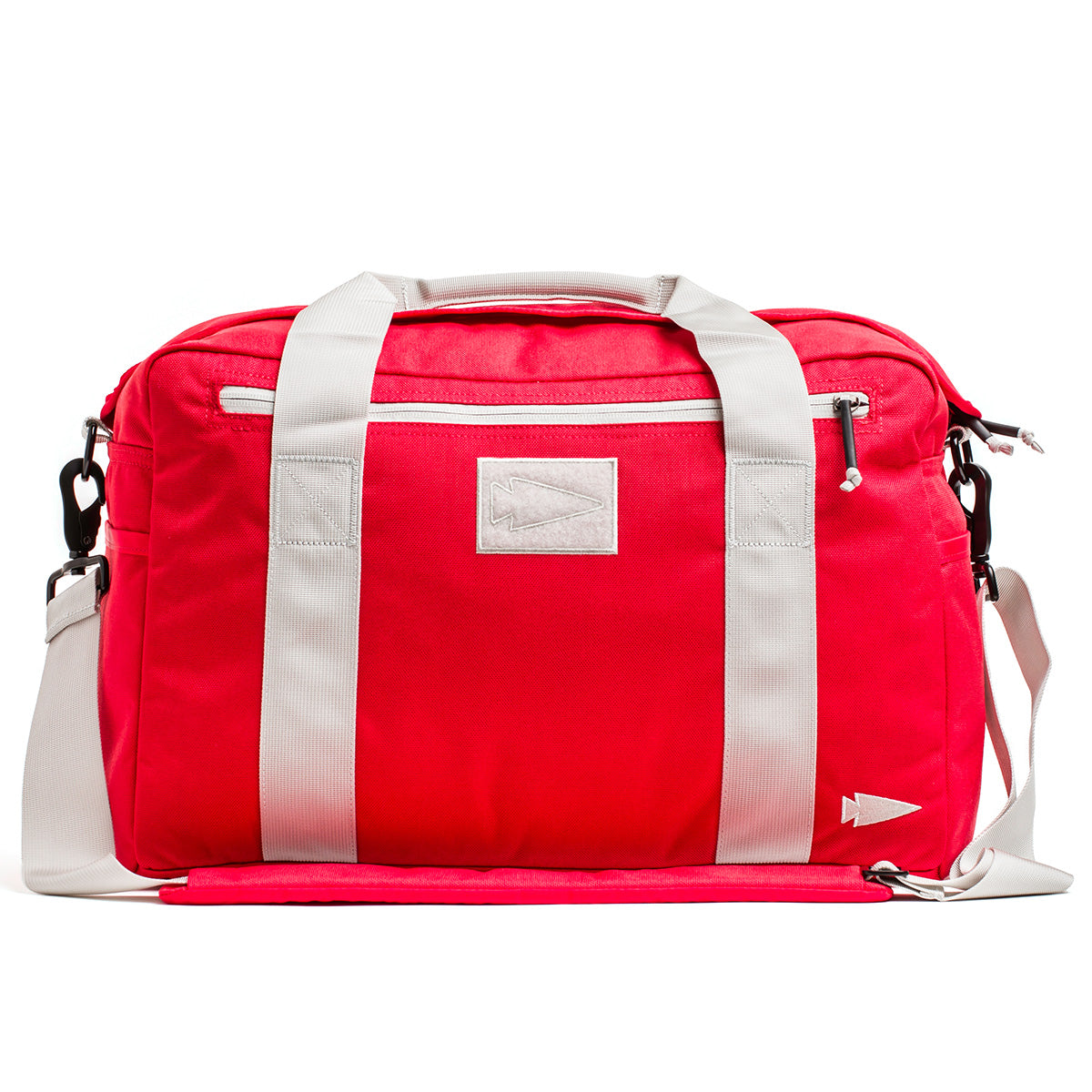 Introducing the GORUCK Kit Bag, a vibrant red duffel with contrasting white handles and an included shoulder strap, designed to resemble a Special Forces Flight Bag. Adorned with a minimal geometric logo and equipped with a convenient front zippered pocket, this bag combines style and utility for adventurous journeys.