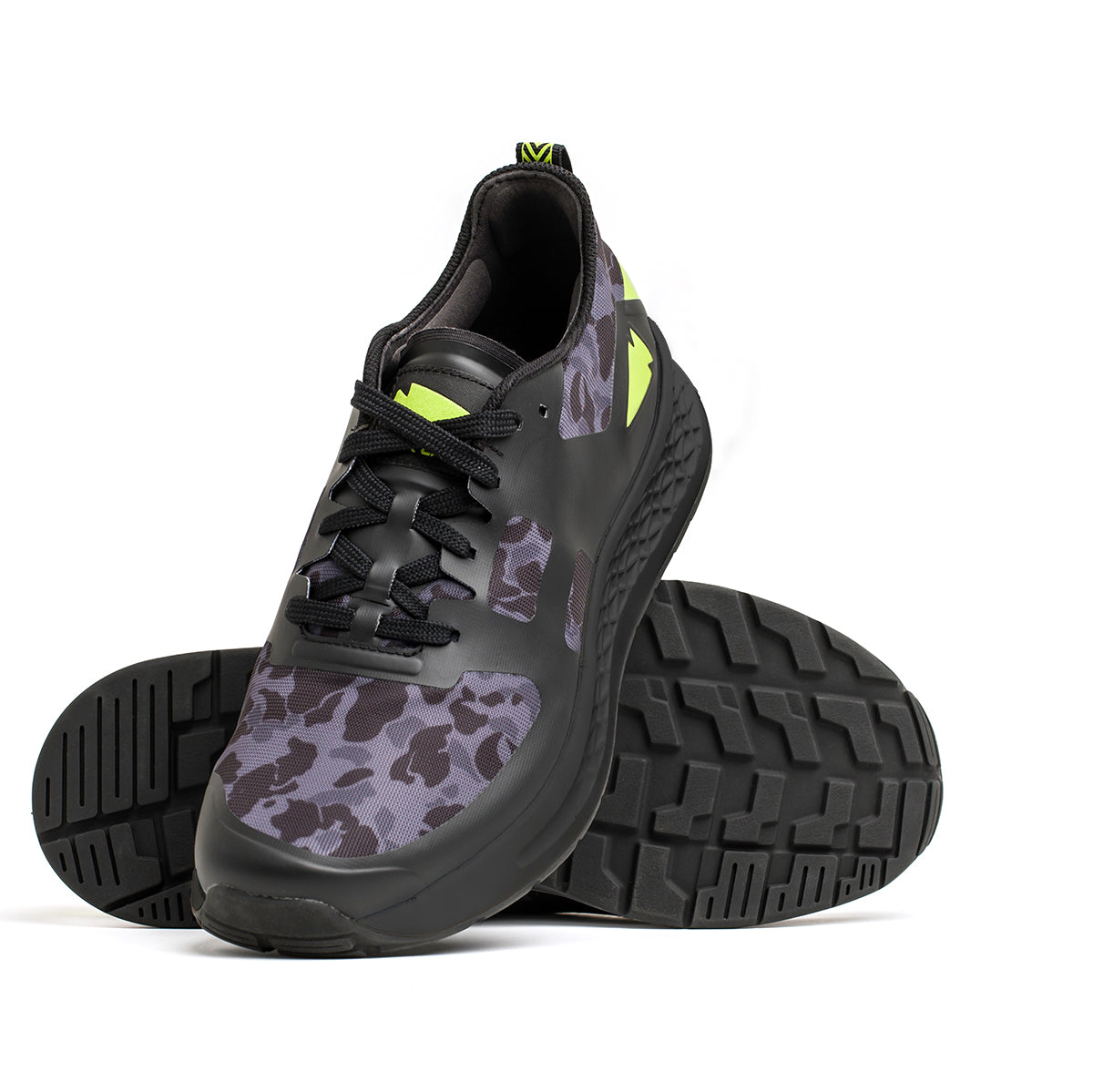 Introducing the Women's Rough Runner - Midnight Frogskin + Acid Lime by GORUCK, featuring a gray and black camouflage pattern with vibrant neon green accents. One shoe is displayed upright while the other is tilted to highlight the textured black sole and GRADIENT DENSITY EVA MIDSOLE. These sleek, lightweight running shoes come equipped with smooth black laces for a stylish finish.