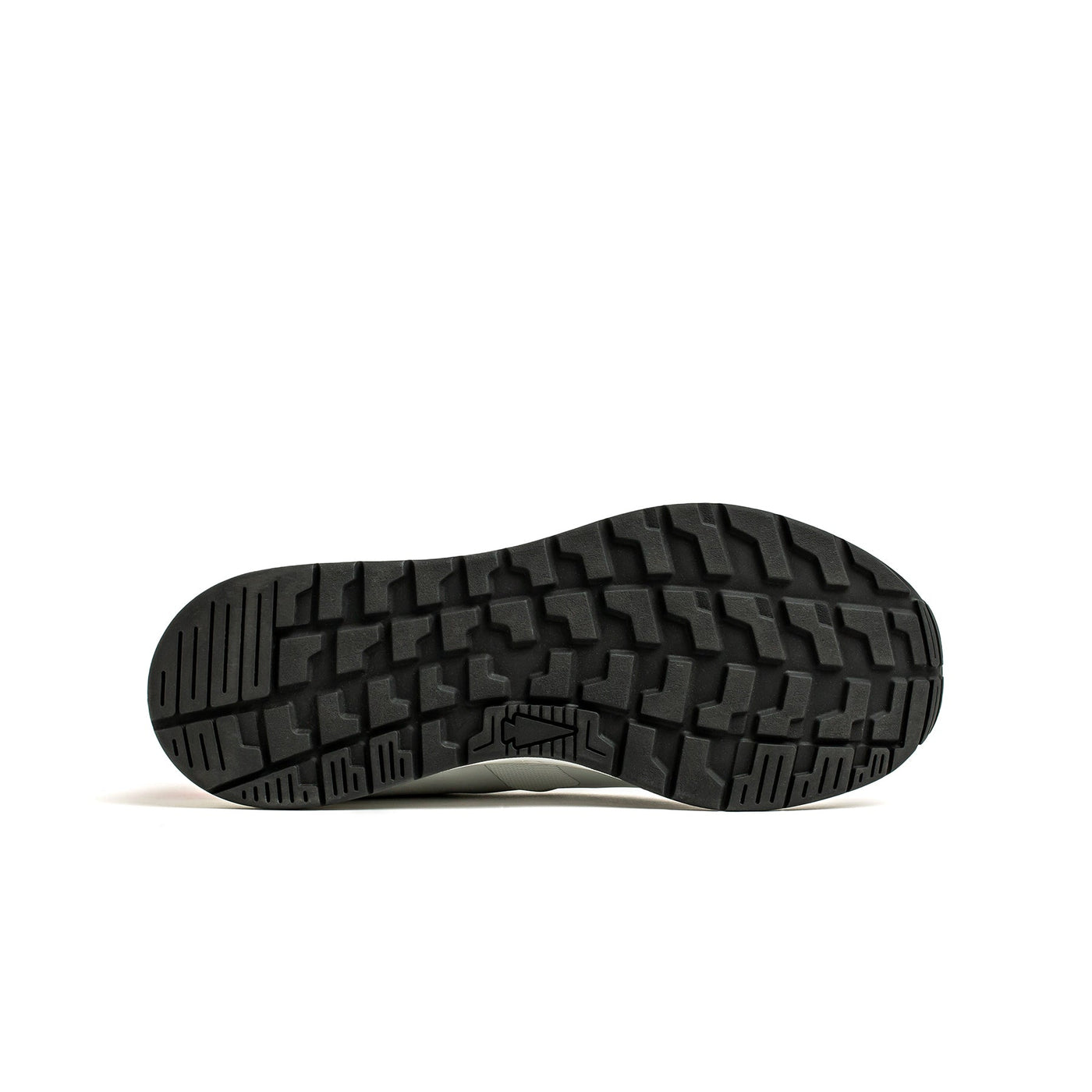 The image showcases the sole of a Women's Rough Runner - Light Grey + Red shoe by GORUCK, featuring a textured, rugged tread pattern. The black sole is crafted to enhance traction with an intricate array of geometric shapes forming a gripping surface against a white background, making it perfect for high mileage running shoes that prioritize durability and performance.