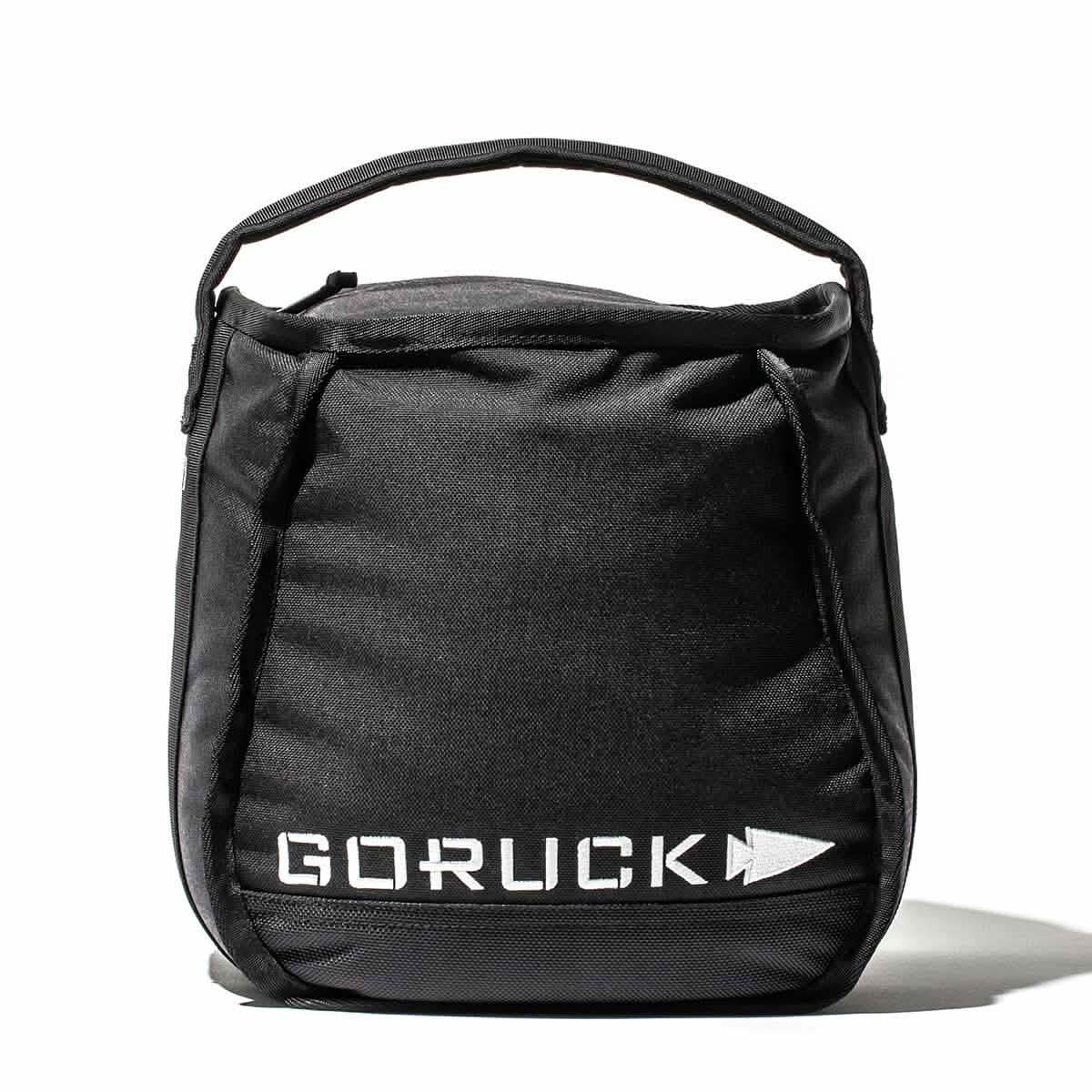 The black backpack from GORUCK, adorned with a white logo on the front and equipped with a handle, is ideal for home training. It's designed to conveniently hold your Sand Kettlebells, ensuring that fitness on the go is both stylish and efficient.