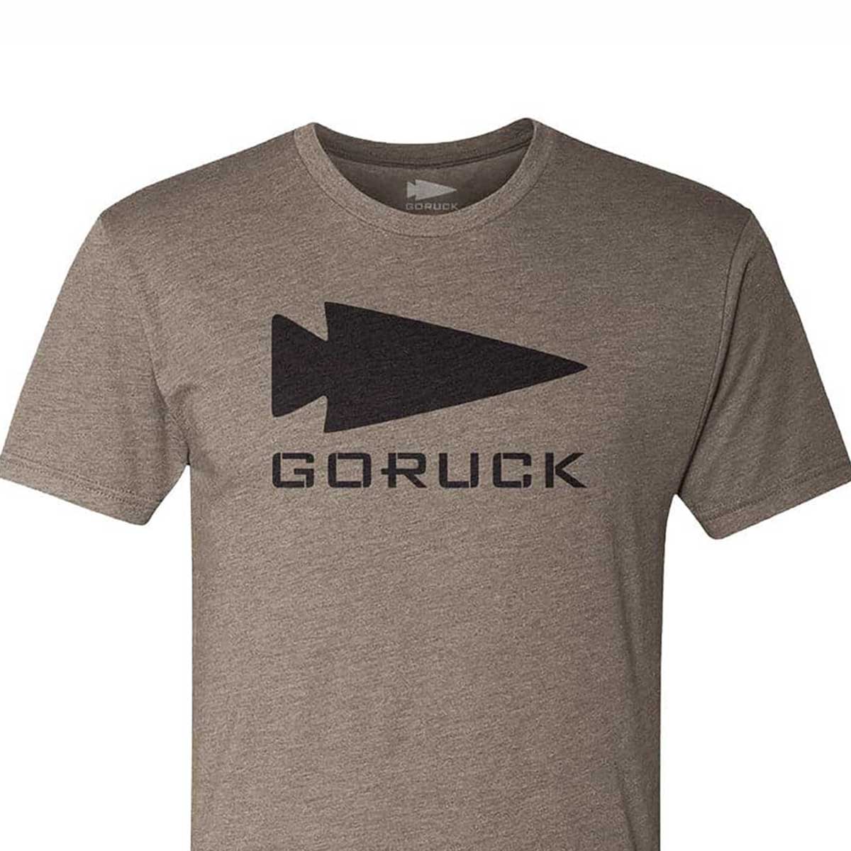 Introducing the GORUCK Spearhead Tee - Tri-Blend from vendor-unknown, a grey t-shirt designed with a premium tri-blend fabric. It features the iconic GORUCK spearhead logo above bold lettering, inspired by Special Forces, centered on the chest area.