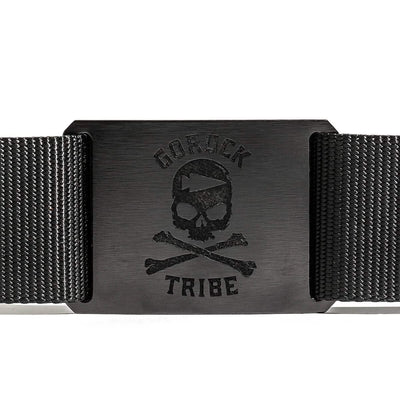 The Tribe Tactical Belt by Grip 6 is a stylish, USA-made black belt featuring a decorative skull and crossbones on a metal buckle with the text "GORUCK TRIBE," offering both style and reliability.